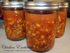 three jars filled with food sitting on top of a counter