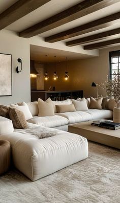 a living room filled with lots of white furniture