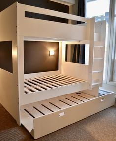 a white bunk bed sitting next to a window in a room with carpeted flooring