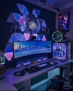 two computer monitors sitting on top of a desk in front of a purple and blue wall