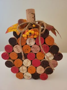 a wine cork pumpkin is decorated with candy