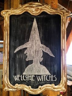 a chalkboard sign with a wizard's hat on it that says welcome witches