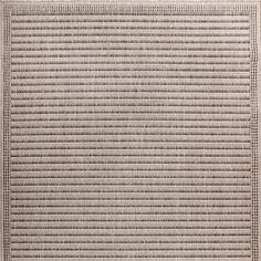 a beige rug with small squares on it