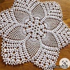 a white doily on top of a wooden table