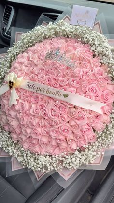 a car decorated with pink roses and baby's breath