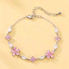 Description:Crystal Cherry Blossom Bracelet Specification:Material: cubic zirconia, rhinestone, copper, silverSize: 16+5cmWeight: 120 g/pcFloral Color: pink Chain Color: silver "Add a touch of whimsy to any outfit with our Crystal Cherry Blossom Bracelet! Made with sparkling crystals and adorned with delicate cherry blossom charms, this bracelet is a playful and unique addition to your jewelry collection. Perfect for any occasion, this bracelet will bring a smile to your face (and wrist!)." Cherry Blossom Crown, Cherry Blossom Bracelet, Simplistic Jewelry, Pink Chain, Bridal Henna Designs, Pretty Jewelry Necklaces, Neck Jewellery, Crystal Beads Bracelet, Pink Jewelry