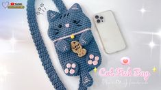 a crocheted cell phone case with a cat on it and a keychain