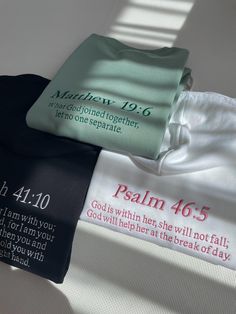 three t - shirts laying on top of each other with the names of two people