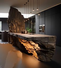 an island made out of rocks in the middle of a room with lights hanging from it