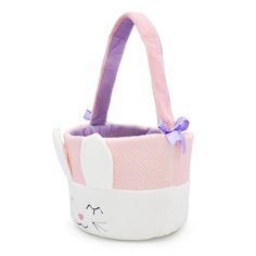 a small pink and white basket with a cat design on it's front side