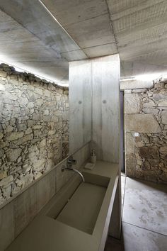 a bathroom with stone walls and flooring