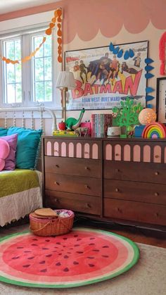 a child's bedroom with a watermelon rug on the floor