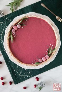 a tart with cranberry sauce and sprigs on top