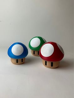 three different colored mushrooms sitting next to each other