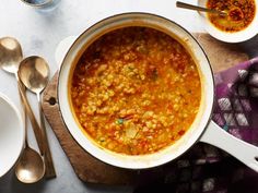 a bowl of soup on a table with spoons