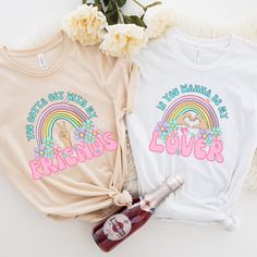 two t - shirts with the words friends and a bottle of booze next to them