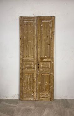 an old wooden door in a white room