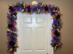 a door decorated with halloween decorations and pumpkins