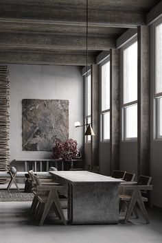 a dining room with chairs and a table in front of two large windows on the wall