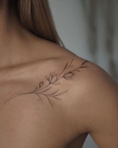 the back of a woman's shoulder with flowers on it