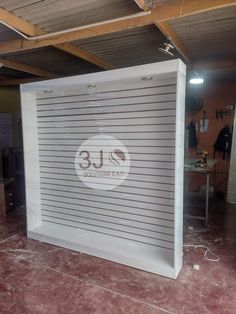 the inside of a garage with an overhead door and metal slats on the wall