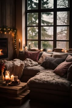 a living room filled with furniture and candles