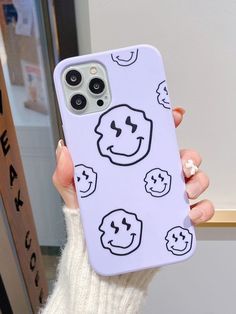 a person holding up a phone case with faces on it