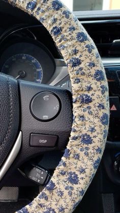 a steering wheel cover with blue flowers on it