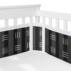 a white crib with black and white panels