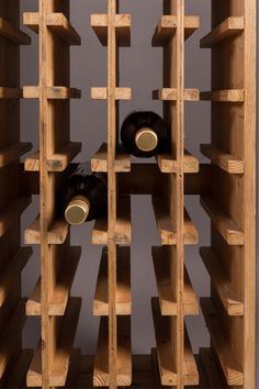 a wooden wine rack filled with lots of bottles