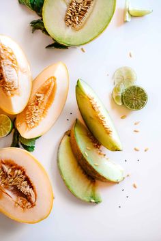 sliced melons and limes on a white surface