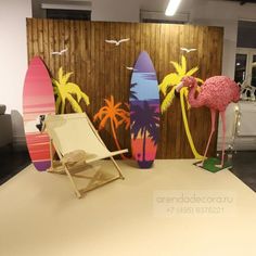 three surfboards and two flamingos are on display