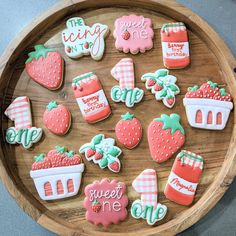 some decorated cookies are on a wooden platter