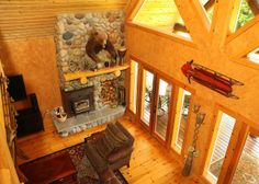 an aerial view of a living room with stone fireplace and wood flooring in the center