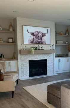 a living room filled with furniture and a fire place in front of a painting on the wall