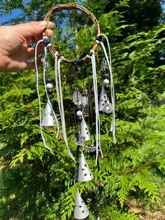 a person is holding a wind chime in their hand