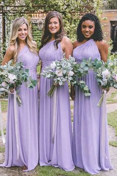 three bridesmaids in lavender colored dresses holding bouquets