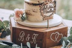 a wedding cake sitting on top of a wooden block