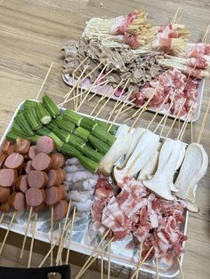 various meats and vegetables on skewers with toothpicks