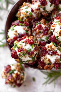 a bowl filled with cranberry bites covered in cheese