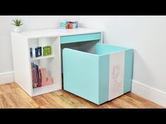 a blue and white bookcase with books in it next to a wall mounted shelf