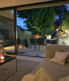 a living room filled with furniture next to a sliding glass door