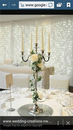 a table set with candles and flowers on it for a wedding reception or special event