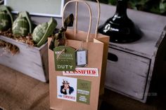 a brown paper bag sitting on top of a wooden table next to a potted plant