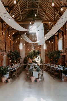 the inside of a building with tables and chairs set up for an event or function