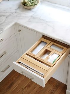 an open drawer in the middle of a kitchen counter