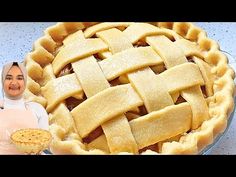 a woman standing next to a pie with latticed crust on it's side