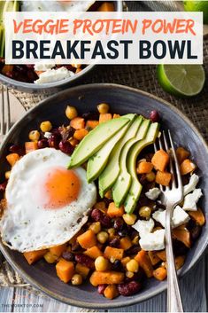 a bowl filled with beans, avocado and an egg next to a fork