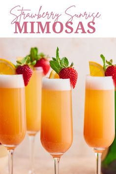 three glasses filled with strawberry sunrise mimosa next to a bottle of wine and strawberries