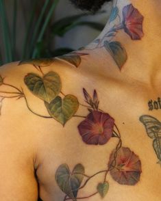 a man with tattoos on his chest and shoulder